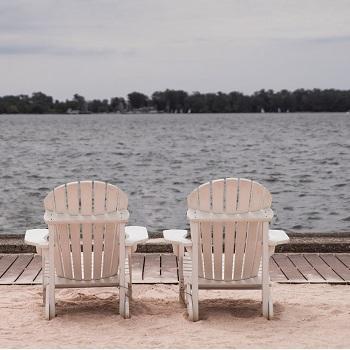 2 beach chairs facing the water