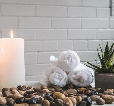 Candle and rolled towels in a SPA setting