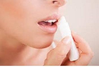 Close up of woman using lip balm