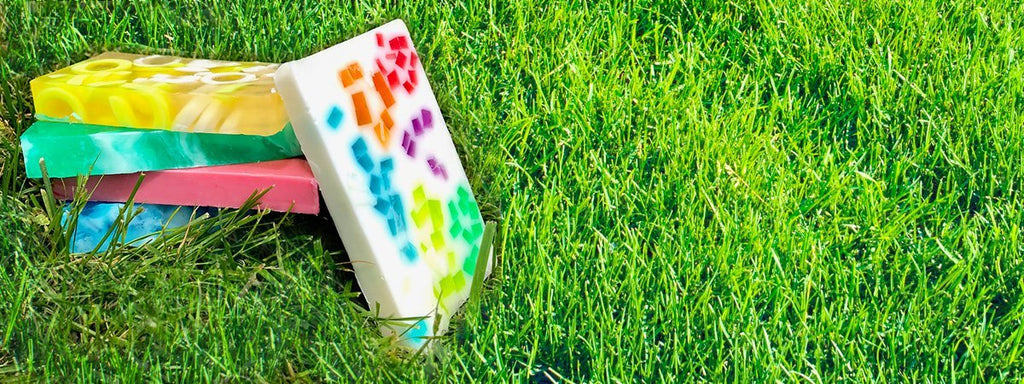A stack of colorful glycerin soaps on grass