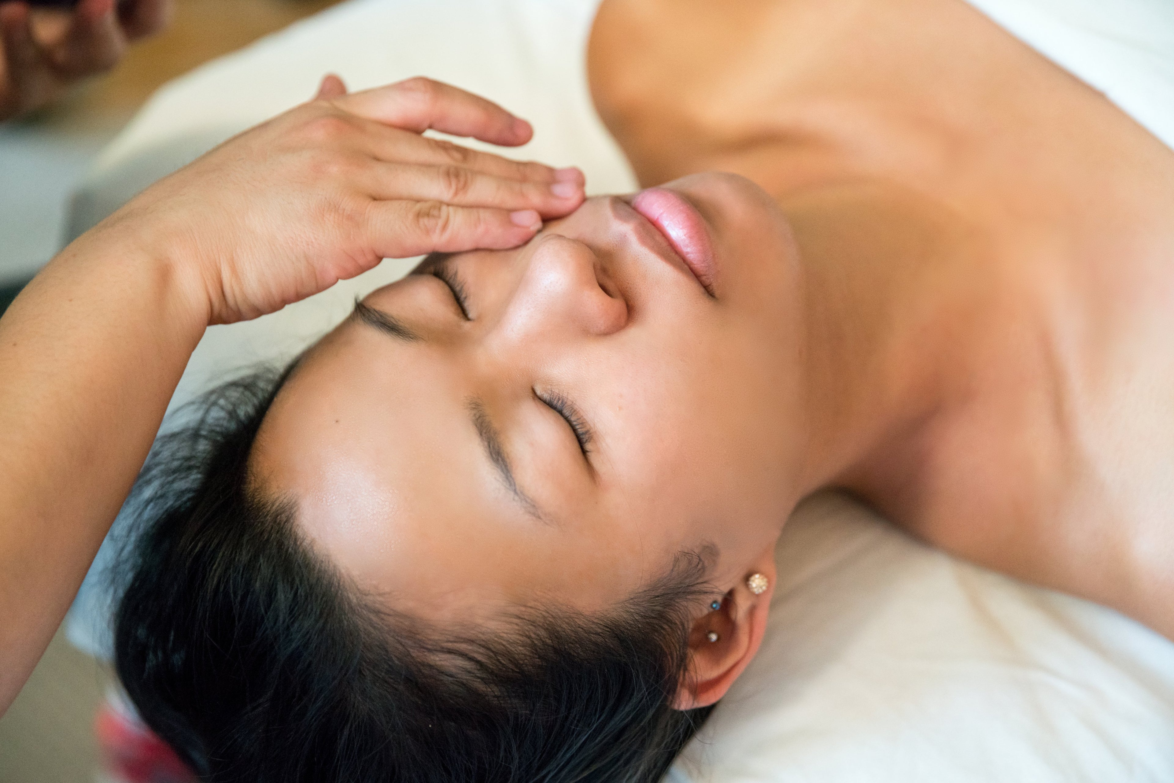 Woman laid down having a face mask applied